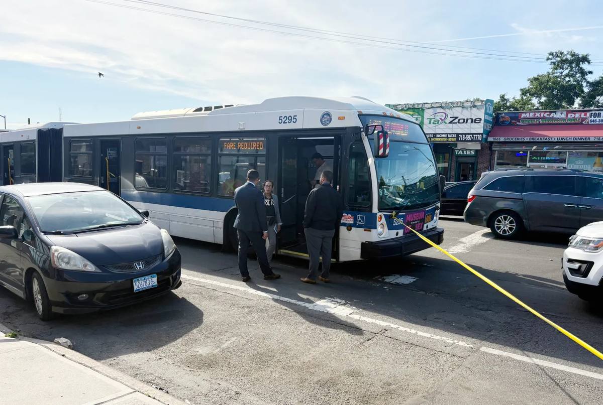 11:29 AMNYPD detectives investigating fatal shooting aboard MTA bus number 5295 on White Plains Road and East Tremont Avenue in the Bronx, New York, with yellow crime scene tape visible near the front of the bus