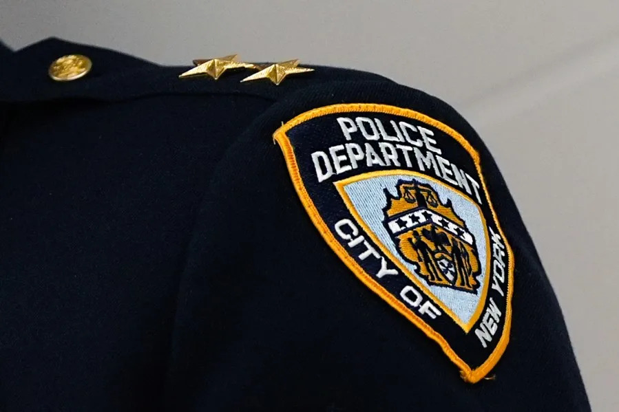 NYPD Police Department City of New York badge on uniform — Brooklyn misconduct settlement lawyer Koenig Pierre