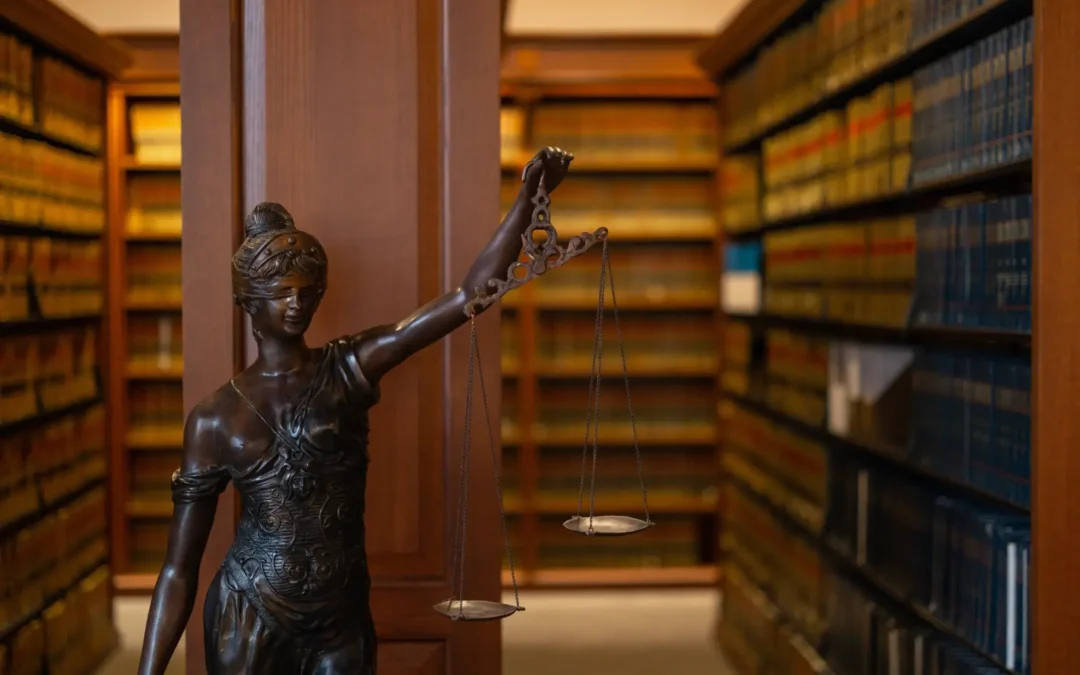 Lady Justice statue holding balanced scales in a law library, symbolizing how to prepare for my EUO under New York no-fault insurance law